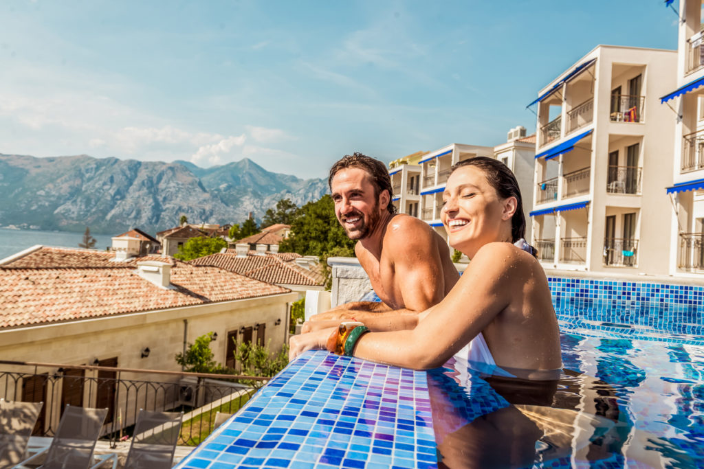 Two people smiling in resort pool